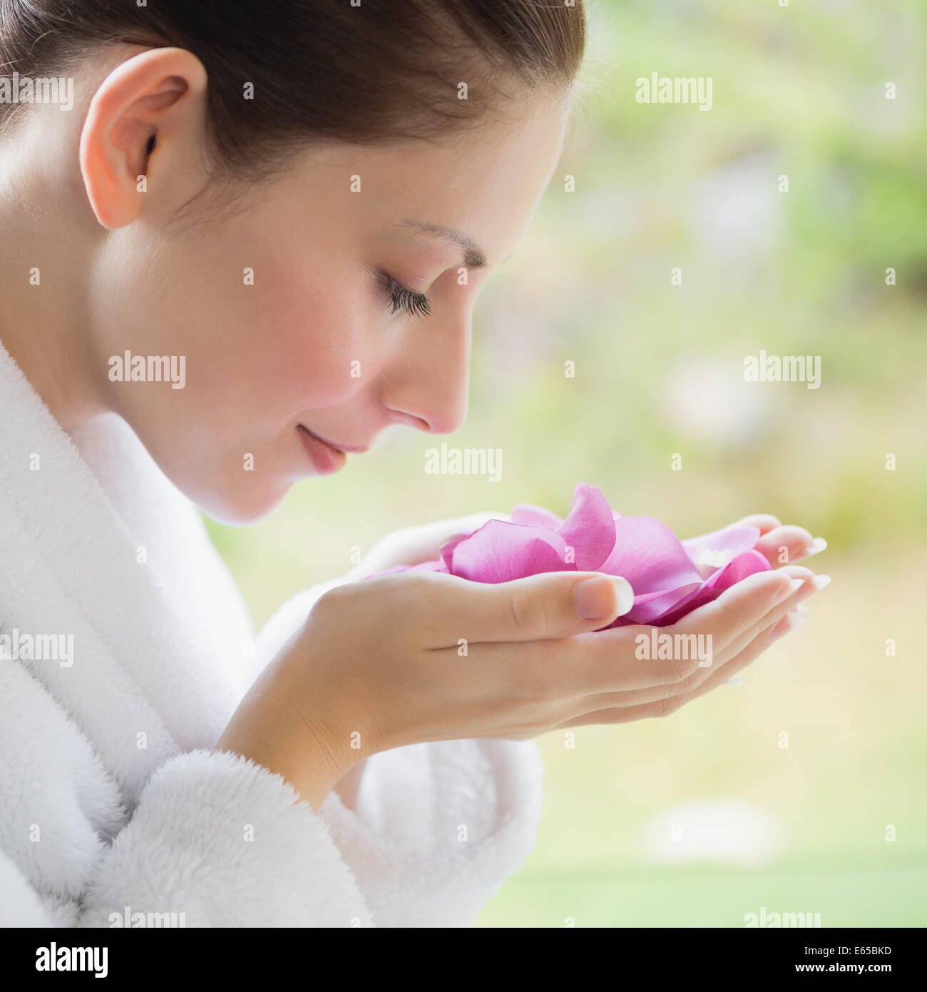 Side view of beautiful woman smelling flowers Stock Photo - Alamy
