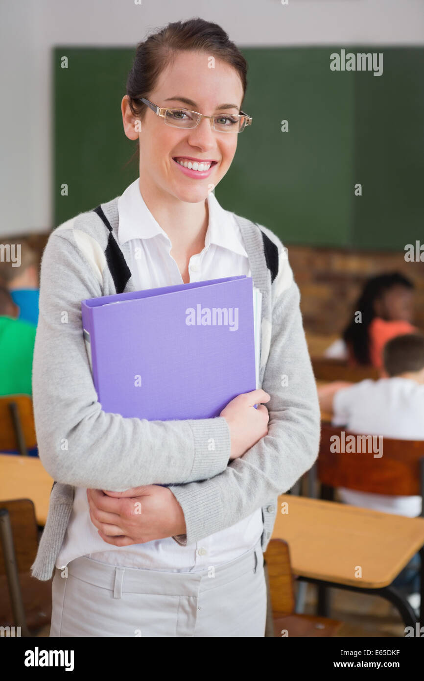 Pretty teacher smiling at camera at back of classroom Stock Photo - Alamy