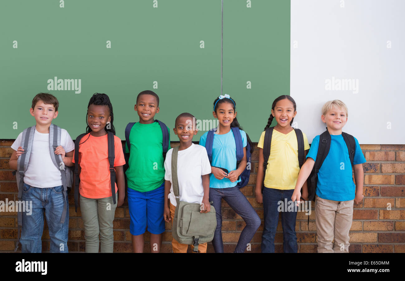 Cute pupils smiling at camera in classroom Stock Photo - Alamy