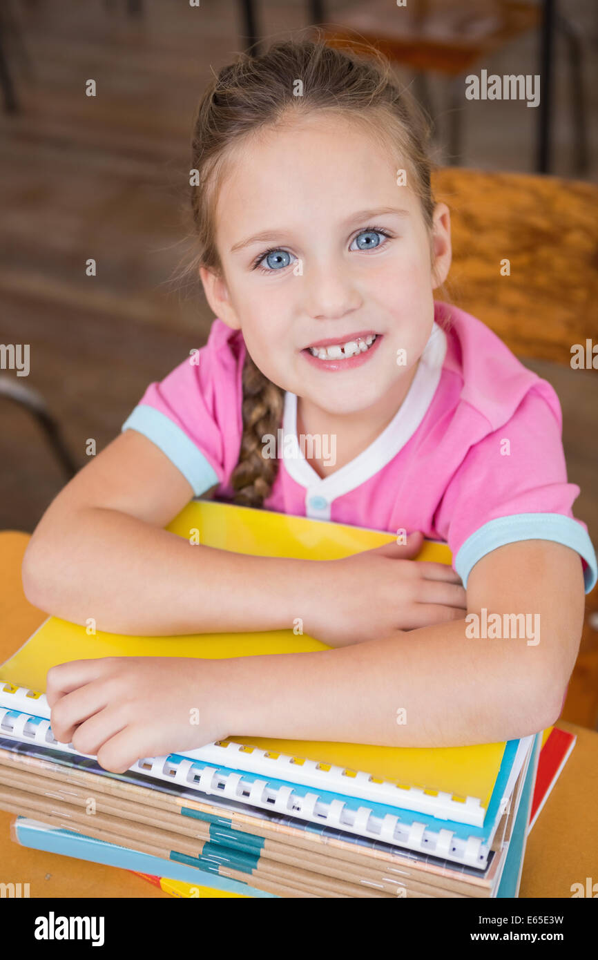 Cute pupil smiling at camera in classroom Stock Photo - Alamy