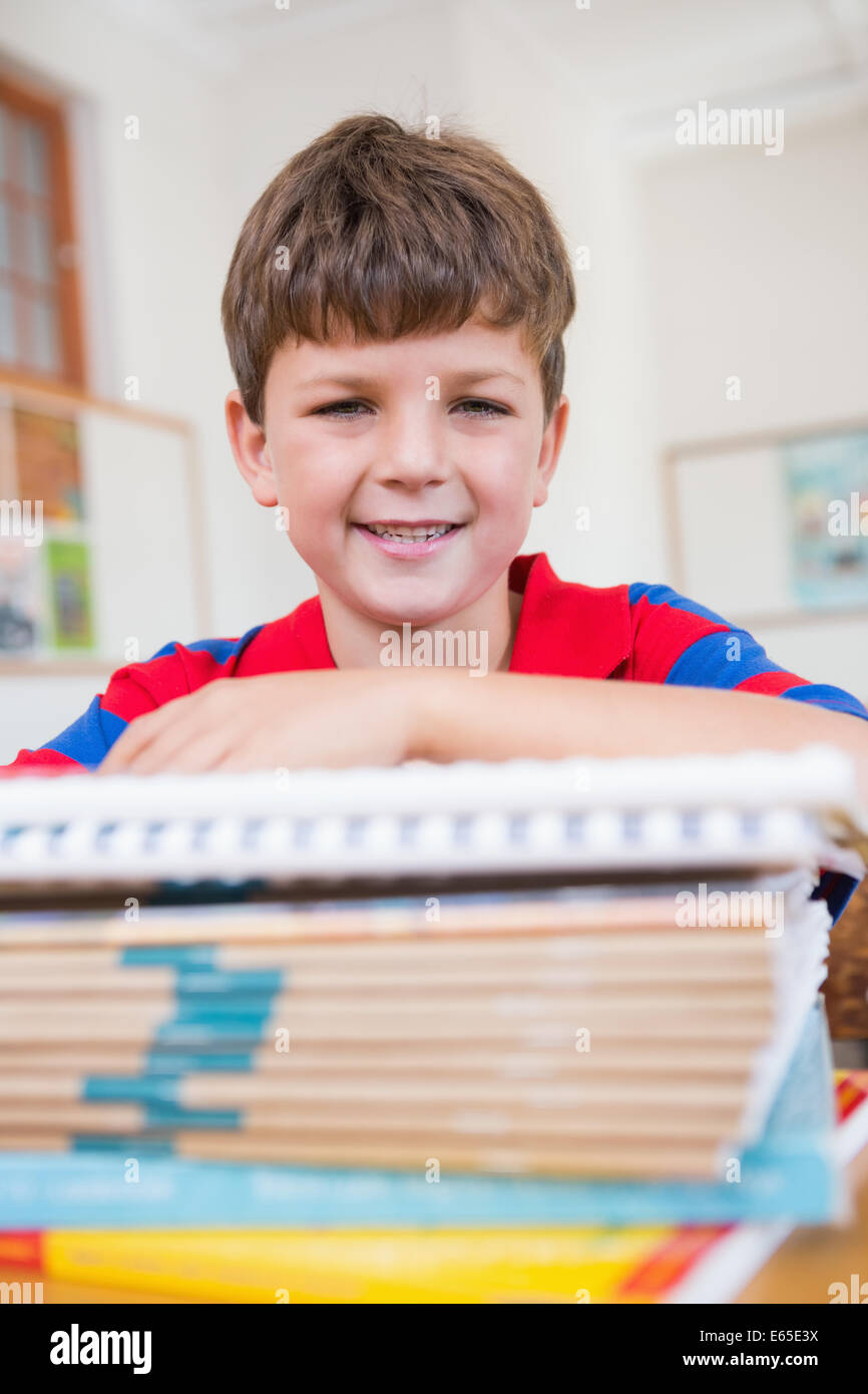Cute pupil smiling at camera in classroom Stock Photo - Alamy