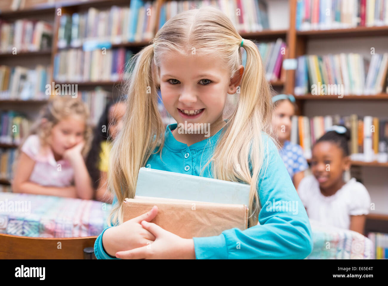 Pupils smiling camera in library hi-res stock photography and images ...