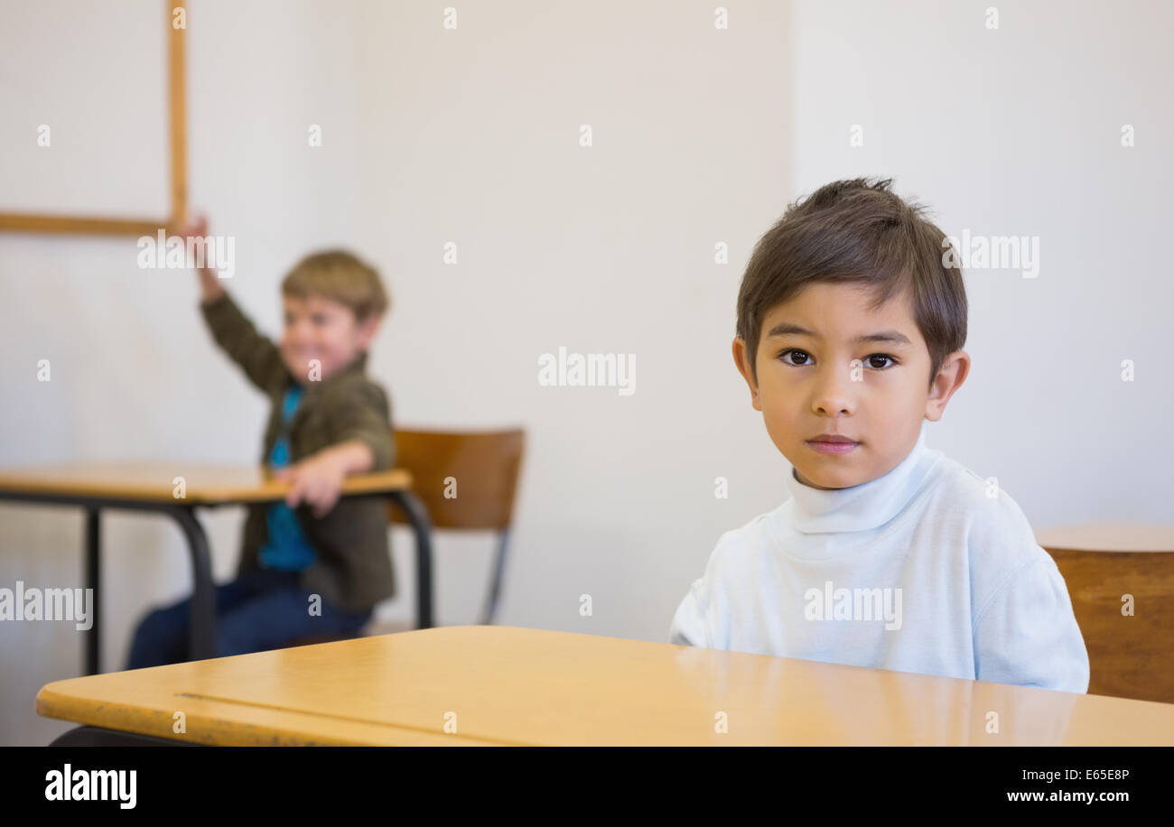 Pupil looking at camera at his desk Stock Photo - Alamy