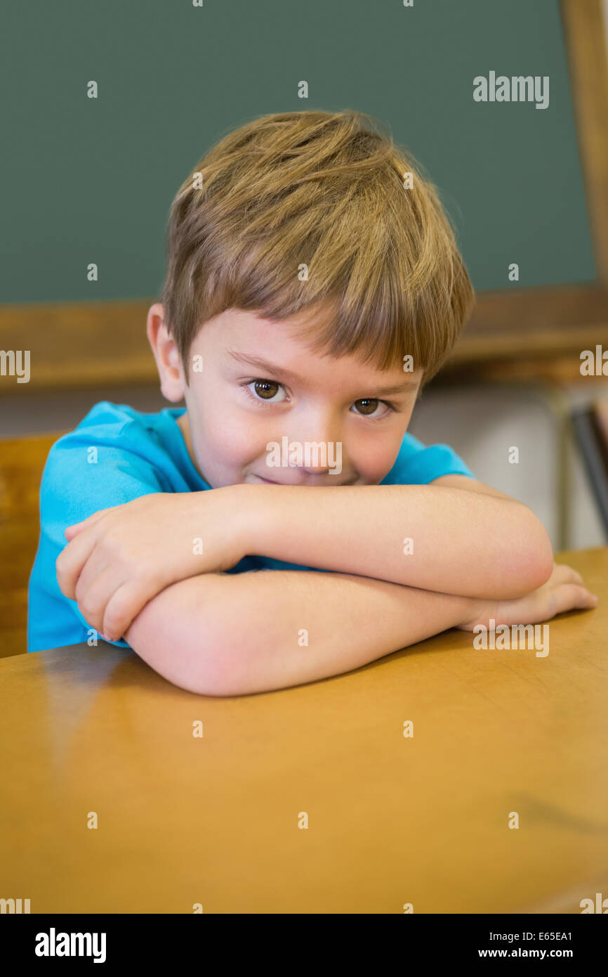 Cute pupil smiling at camera in classroom Stock Photo - Alamy