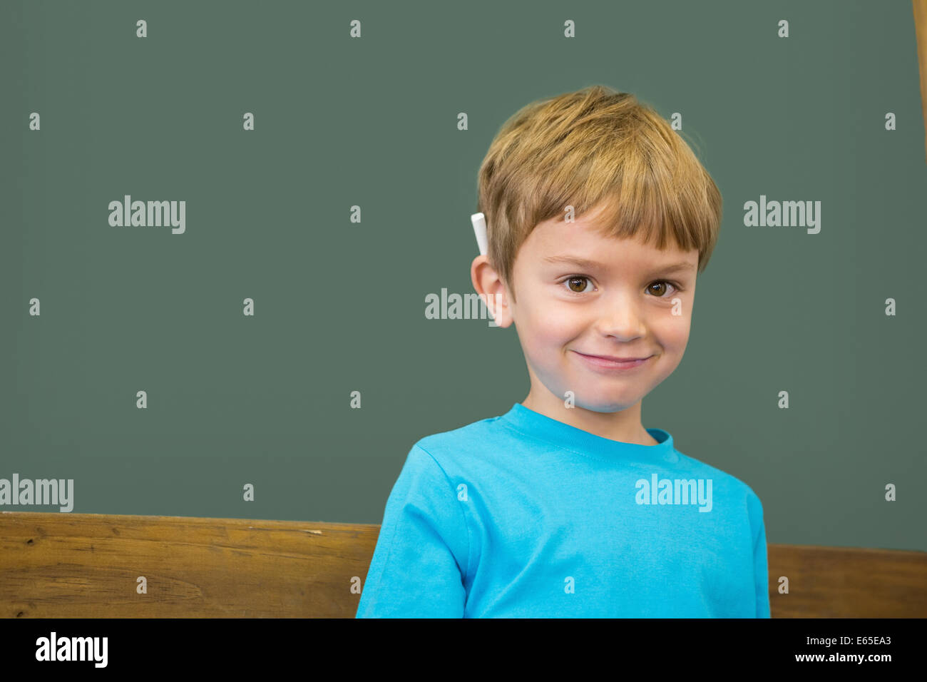 Cute pupil smiling at camera in classroom Stock Photo - Alamy