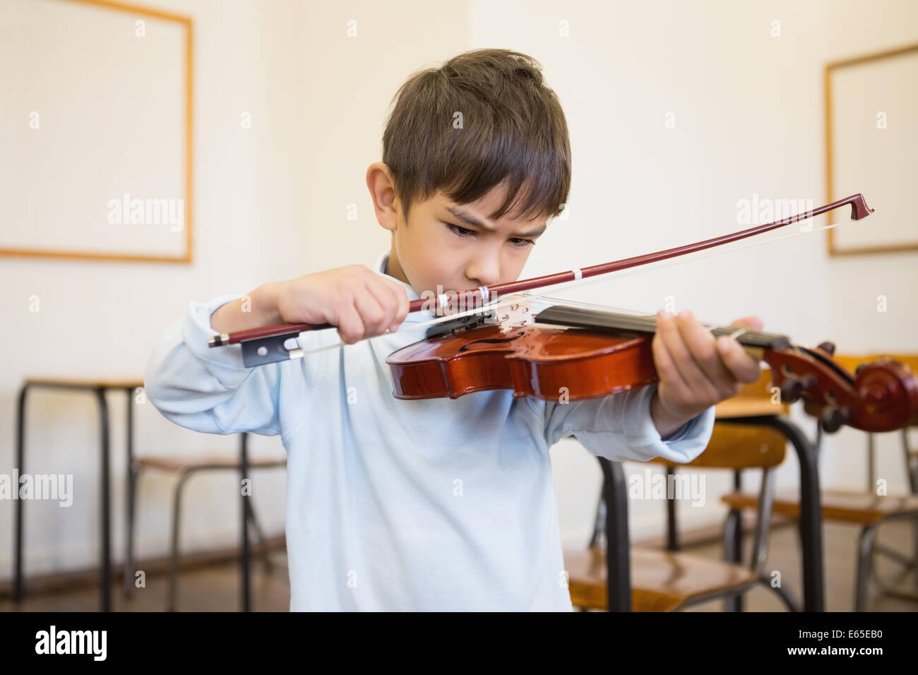 Cute pupil playing violin in classroom Stock Photo - Alamy