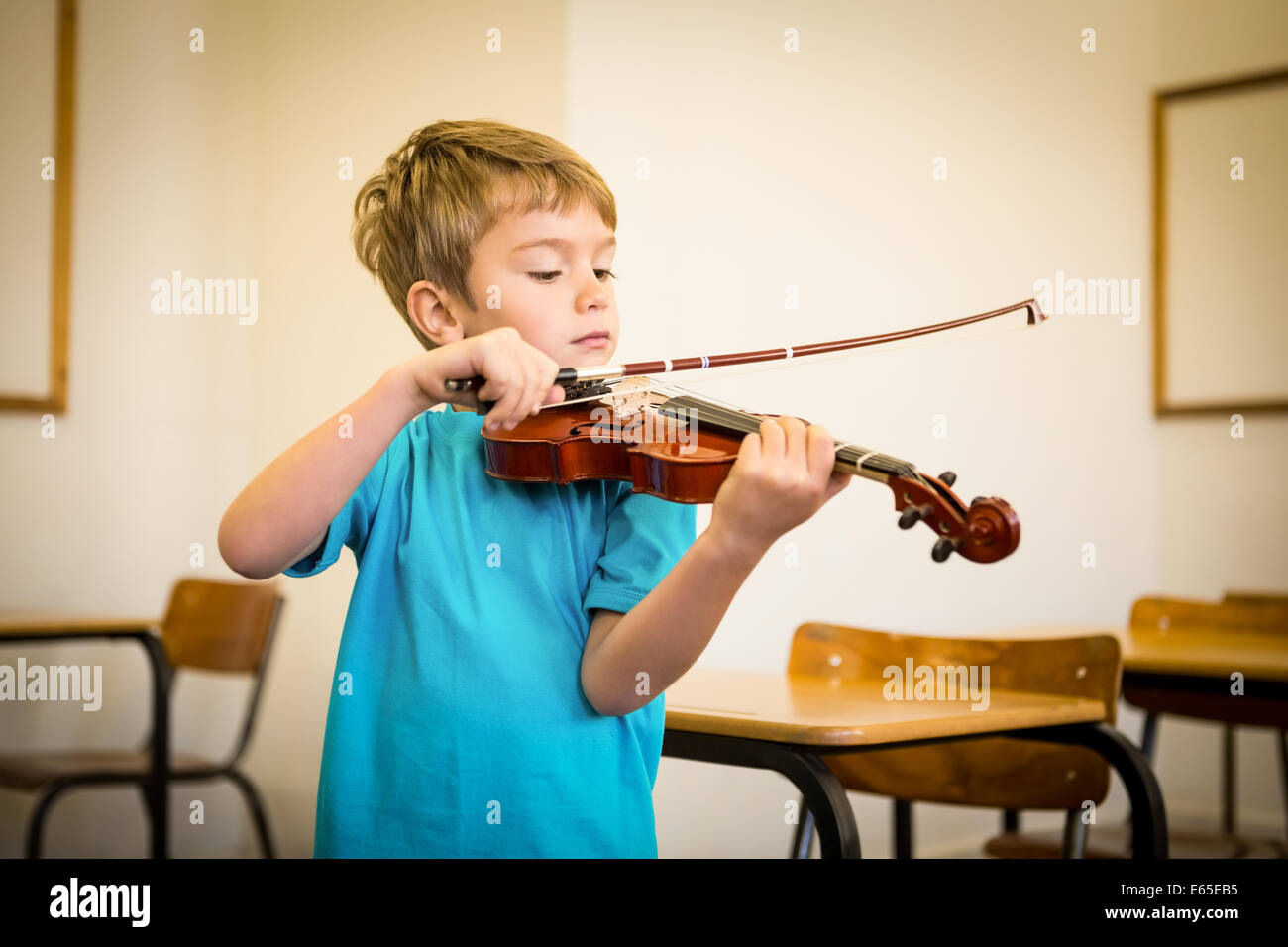 Cute pupil playing violin in classroom Stock Photo - Alamy