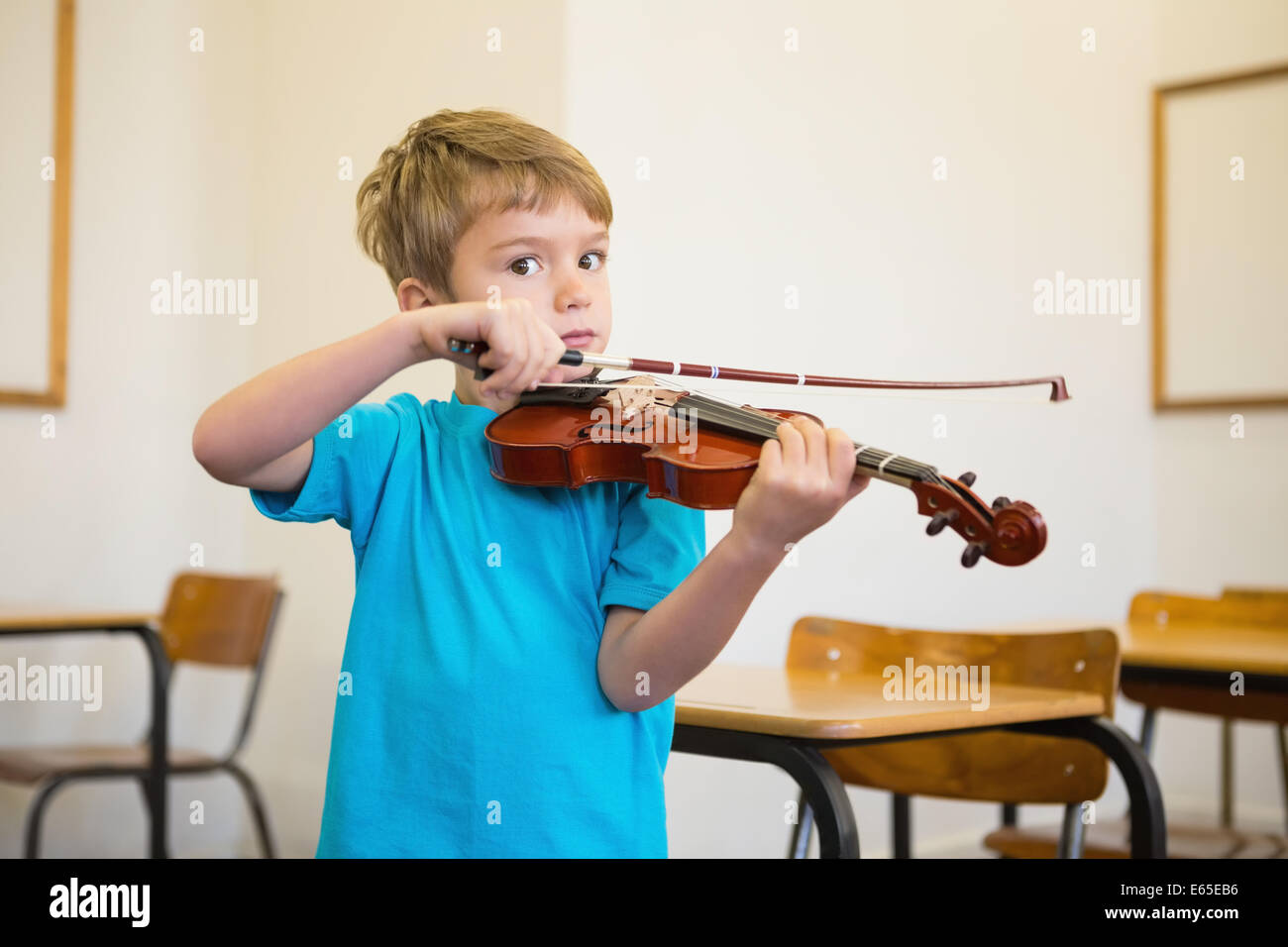 Cute pupil playing violin in classroom Stock Photo - Alamy