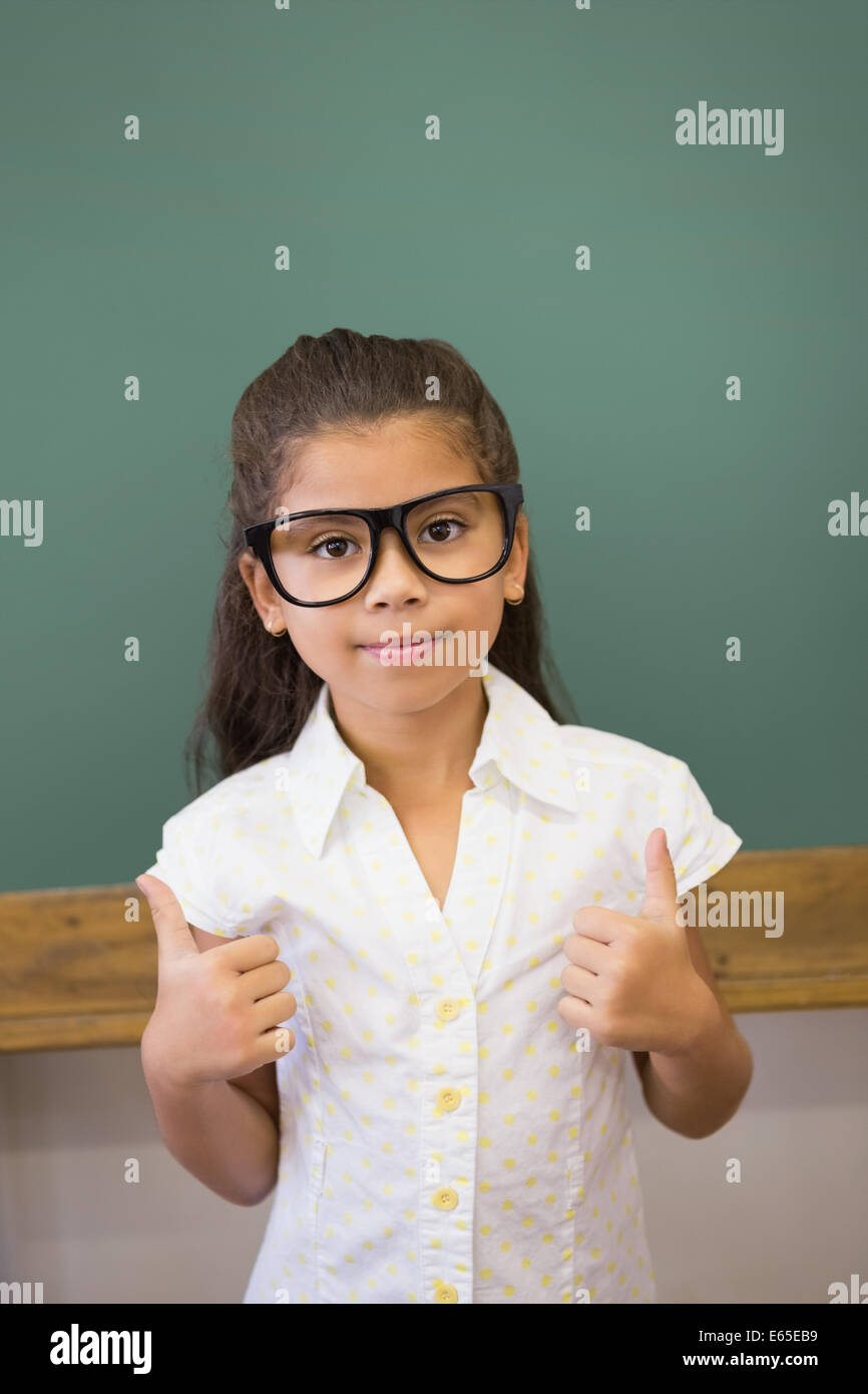 Cute pupil smiling at camera in classroom Stock Photo - Alamy
