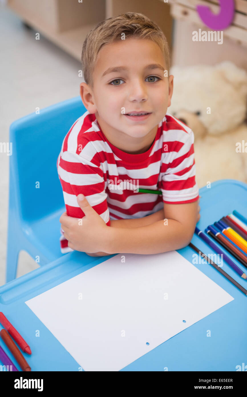 Cute little boy sitting at desk Stock Photo Alamy