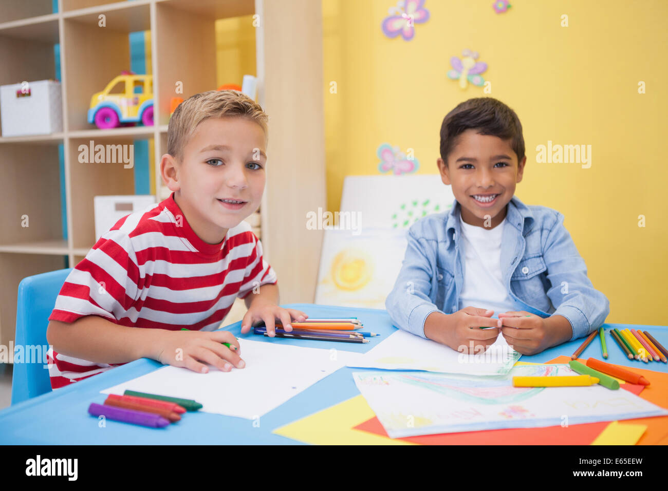 Cute little boys drawing at desk Stock Photo - Alamy