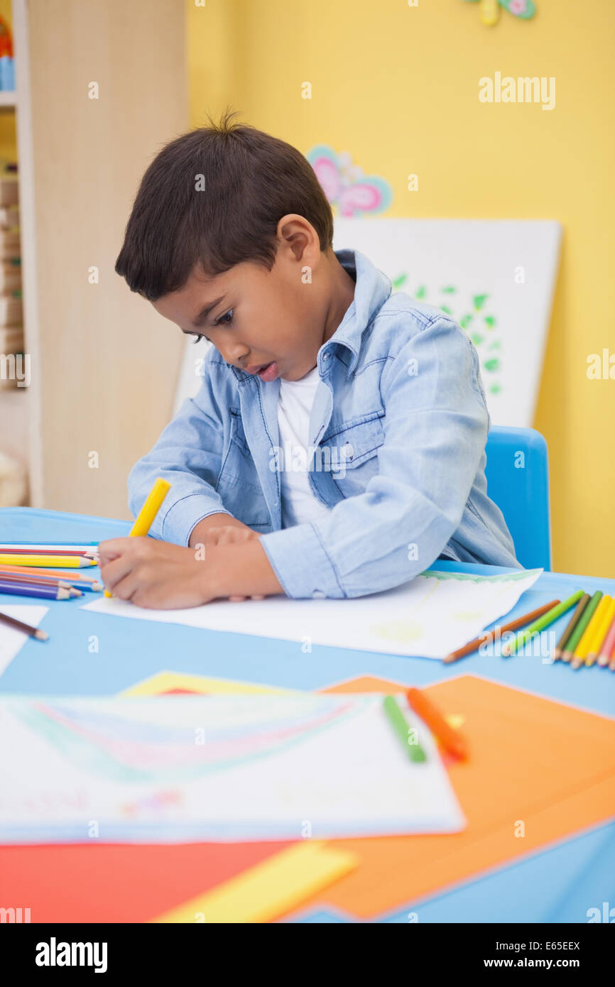 Cute little boy drawing at desk Stock Photo - Alamy