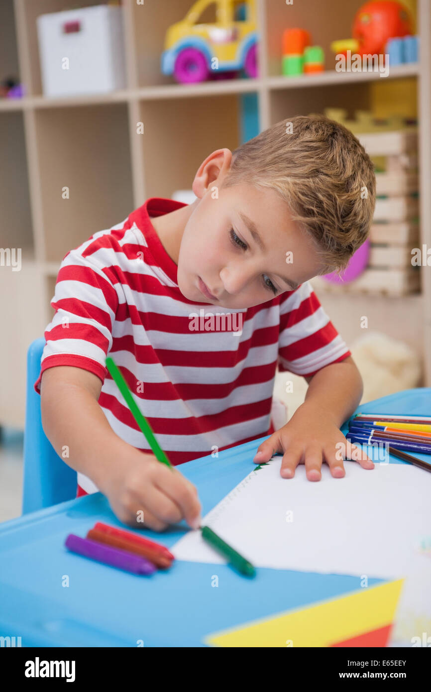 Cute little boy drawing at desk Stock Photo - Alamy