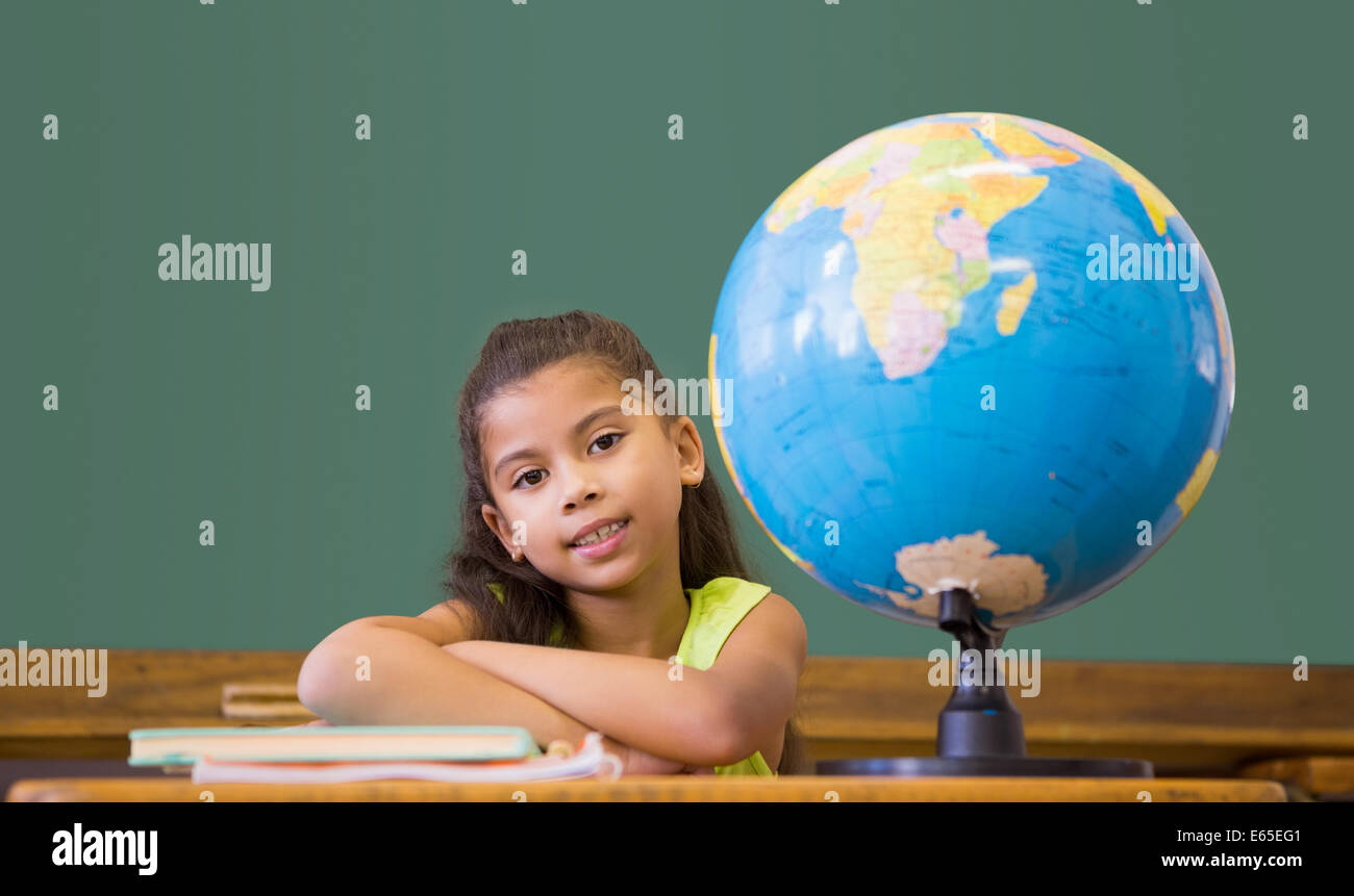 Cute pupil smiling at camera in classroom Stock Photo - Alamy