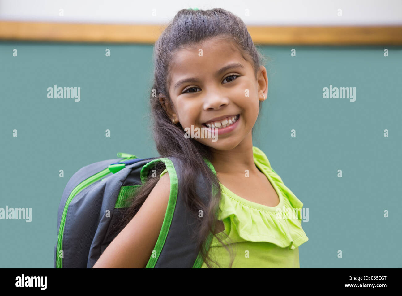 Cute pupil smiling at camera in classroom Stock Photo - Alamy