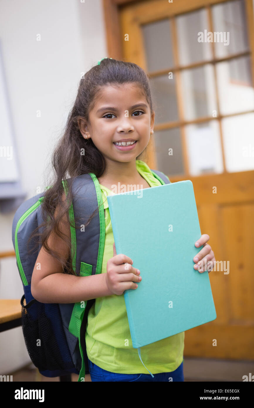 Cute pupil smiling at camera in classroom Stock Photo - Alamy