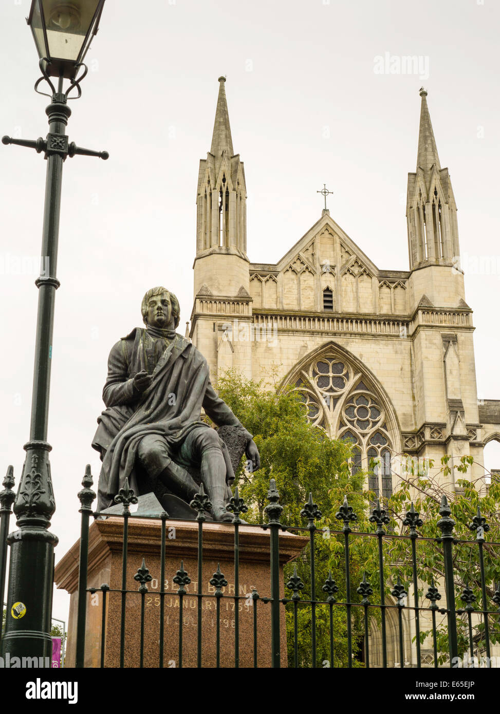 A low-angle view of the Robert Burns statue and St. Paul's Cathedral, from the Octagon, Dunedin, New Zealand Stock Photo