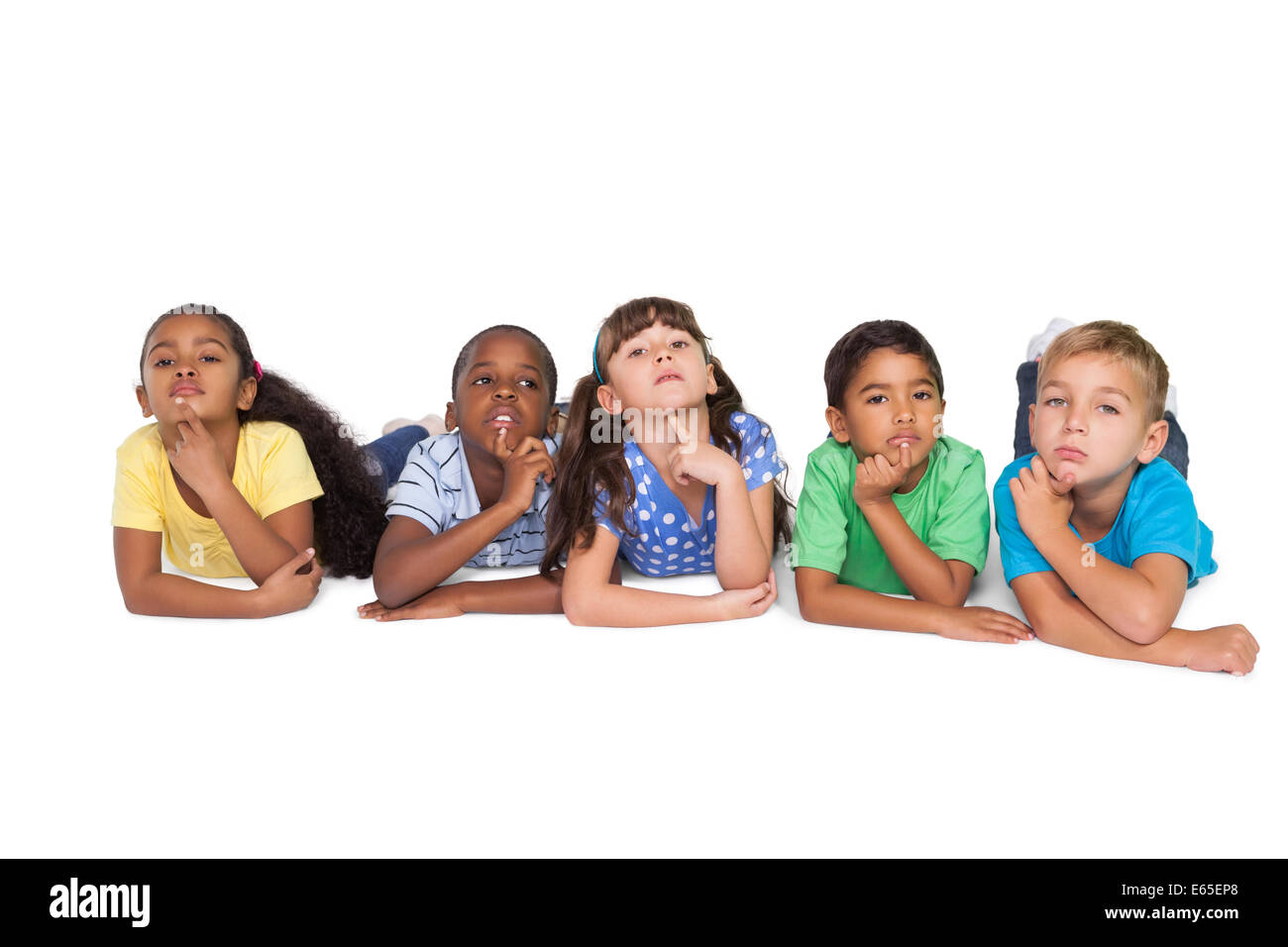 Cute schoolchildren lying and thinking Stock Photo