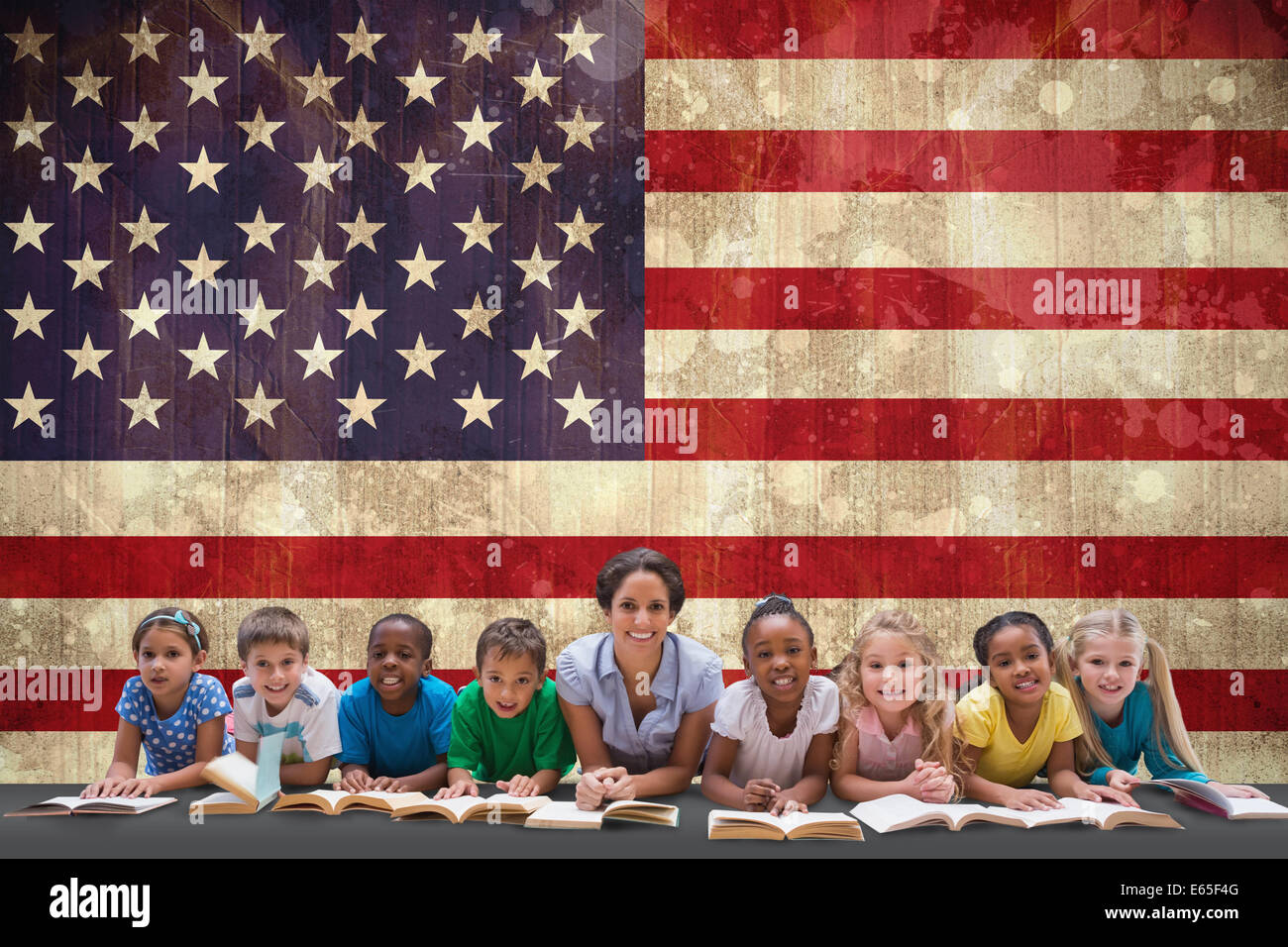 Composite image of cute pupils smiling at camera with teacher Stock ...