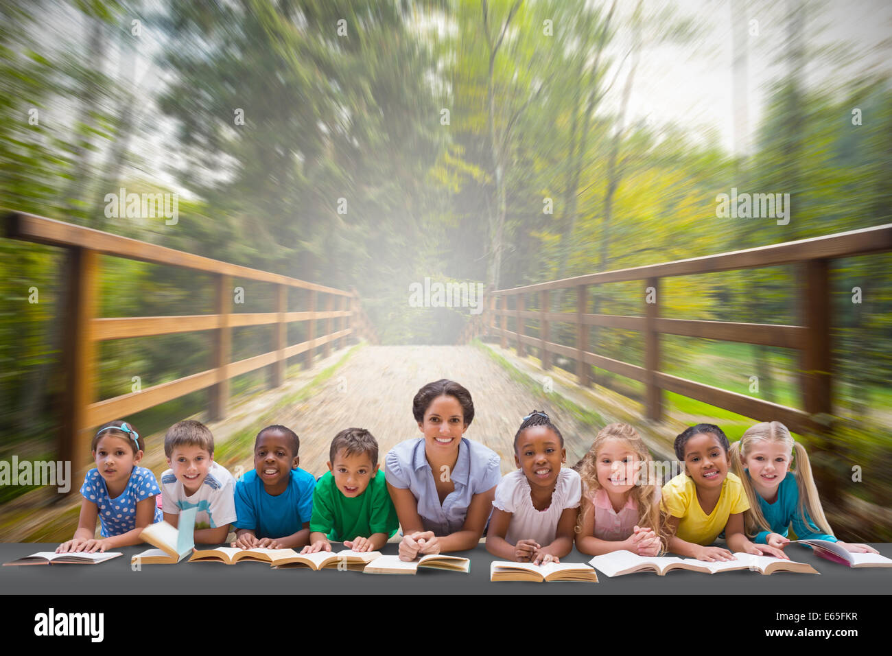 Composite image of cute pupils smiling at camera with teacher Stock ...