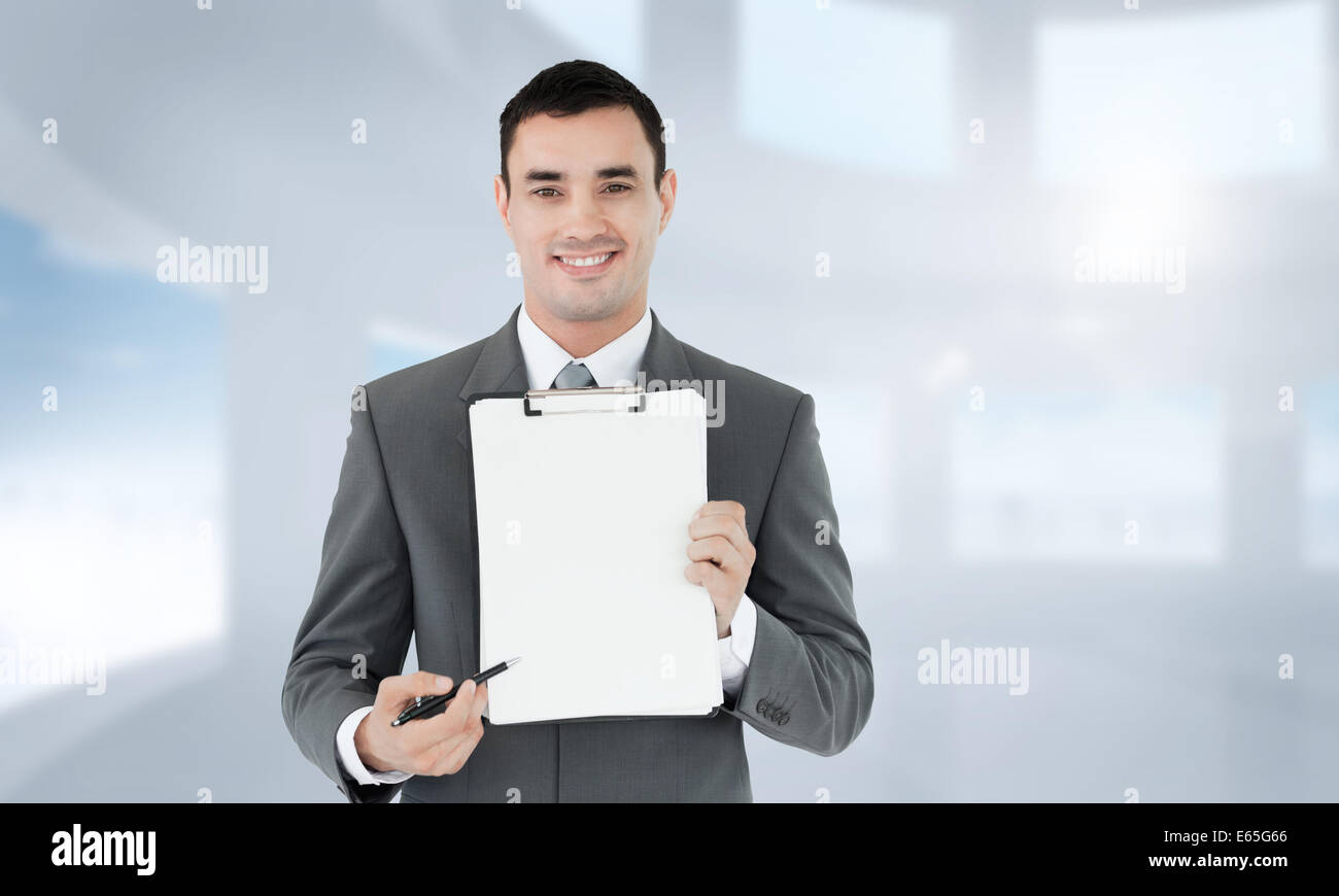 Composite image of businessman pointing with pen on clipboard Stock ...
