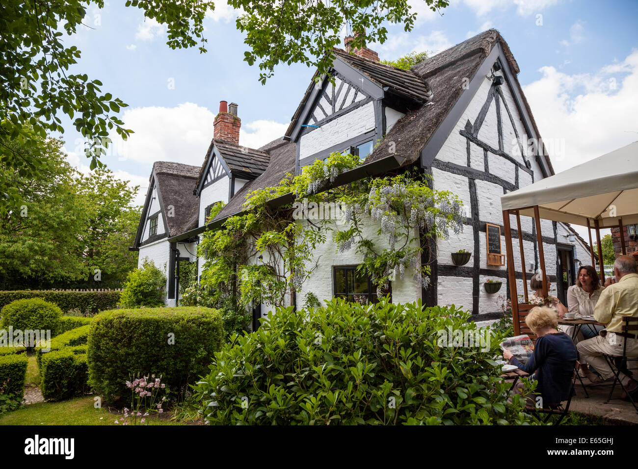 The black and white thatched White Cottage Tea Rooms Little Bollington Cheshire England UK Stock