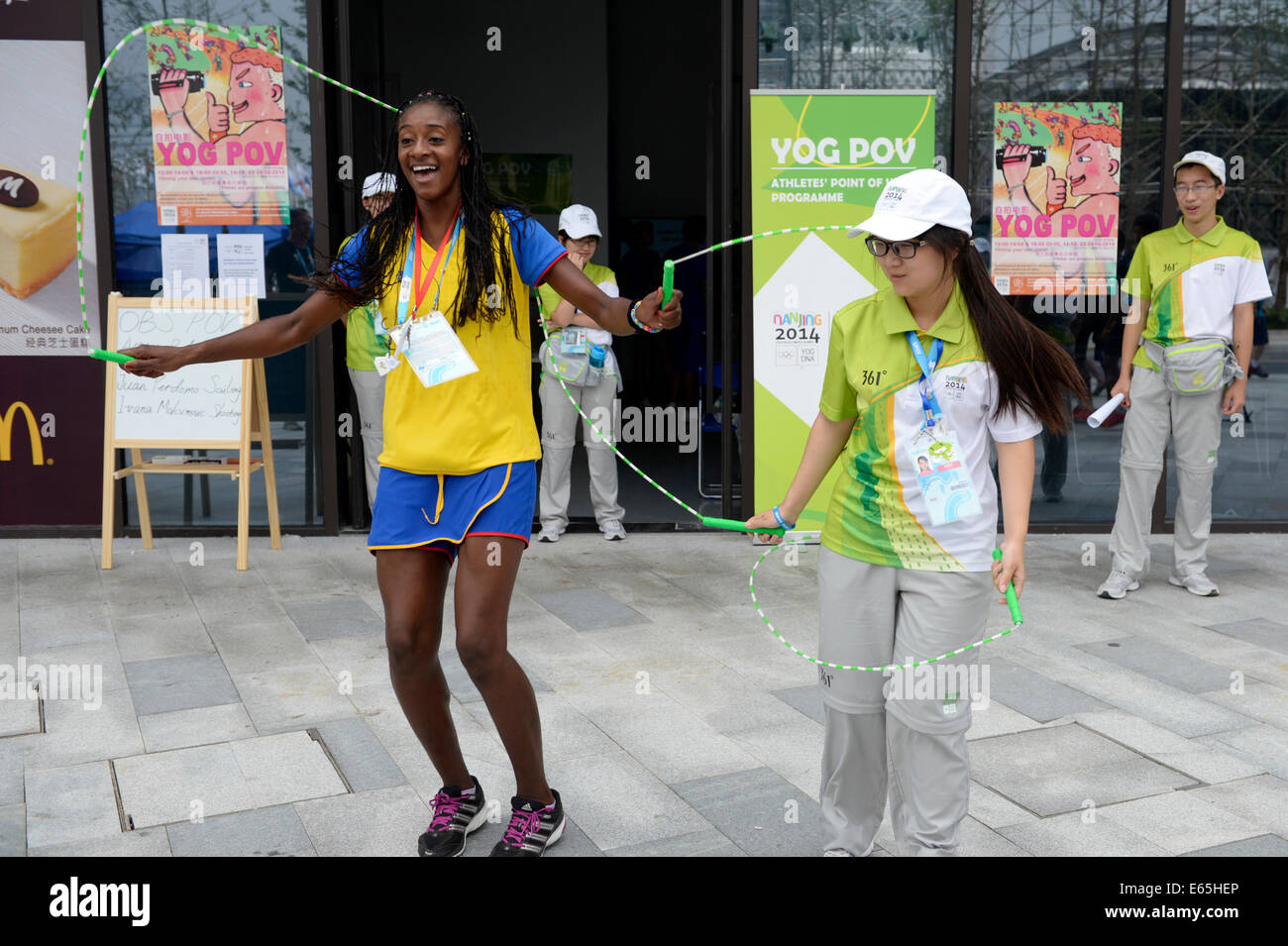 Nanjing, China's Jiangsu Province. 15th Aug, 2014. Astrid Carolina Balanta Colorado(L) of Colombia enjoys the game with volunteers in the Youth Olympic Village of Nanjing 2014 Olympic Games in Nanjing, capital of east China's Jiangsu Province, on Aug. 15, 2014. Credit:  Ju Huanzong/Xinhua/Alamy Live News Stock Photo