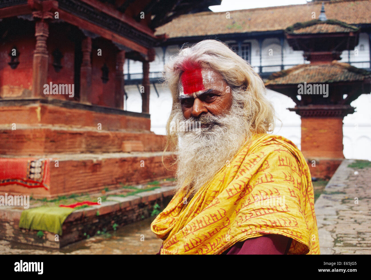Hindu ascetic ('sadhu') in a temple with typical Newari design ( Nepal) Stock Photo