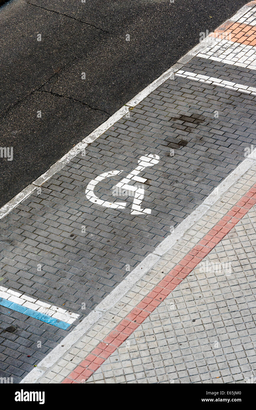 Handicap parking space. Universal symbol painted on the floor Stock Photo