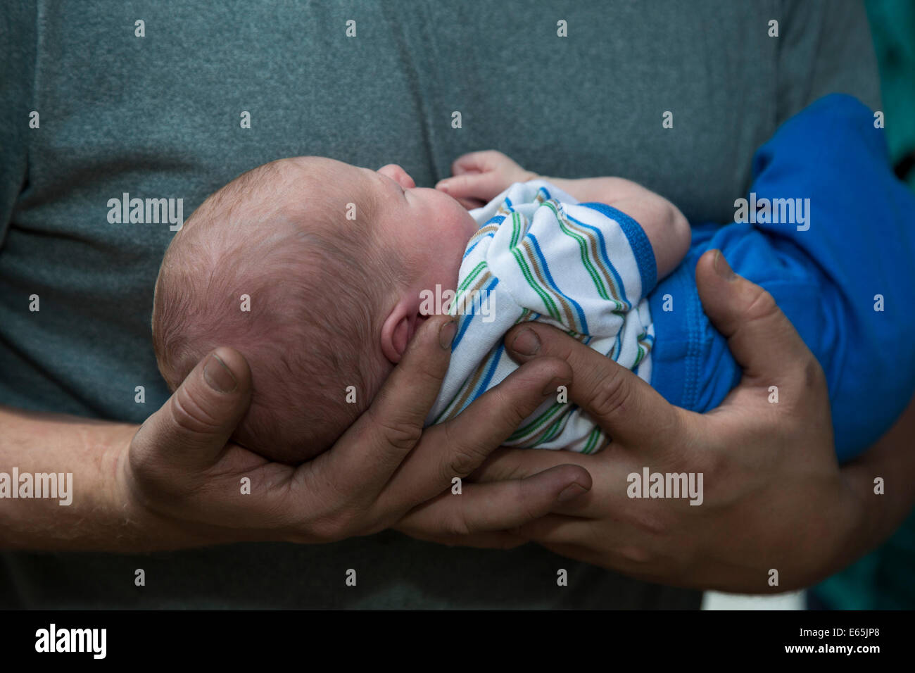 Denver, Colorado - Adam Hjermstad holds his two-week-old son, Adam Hjermstad Jr. Stock Photo