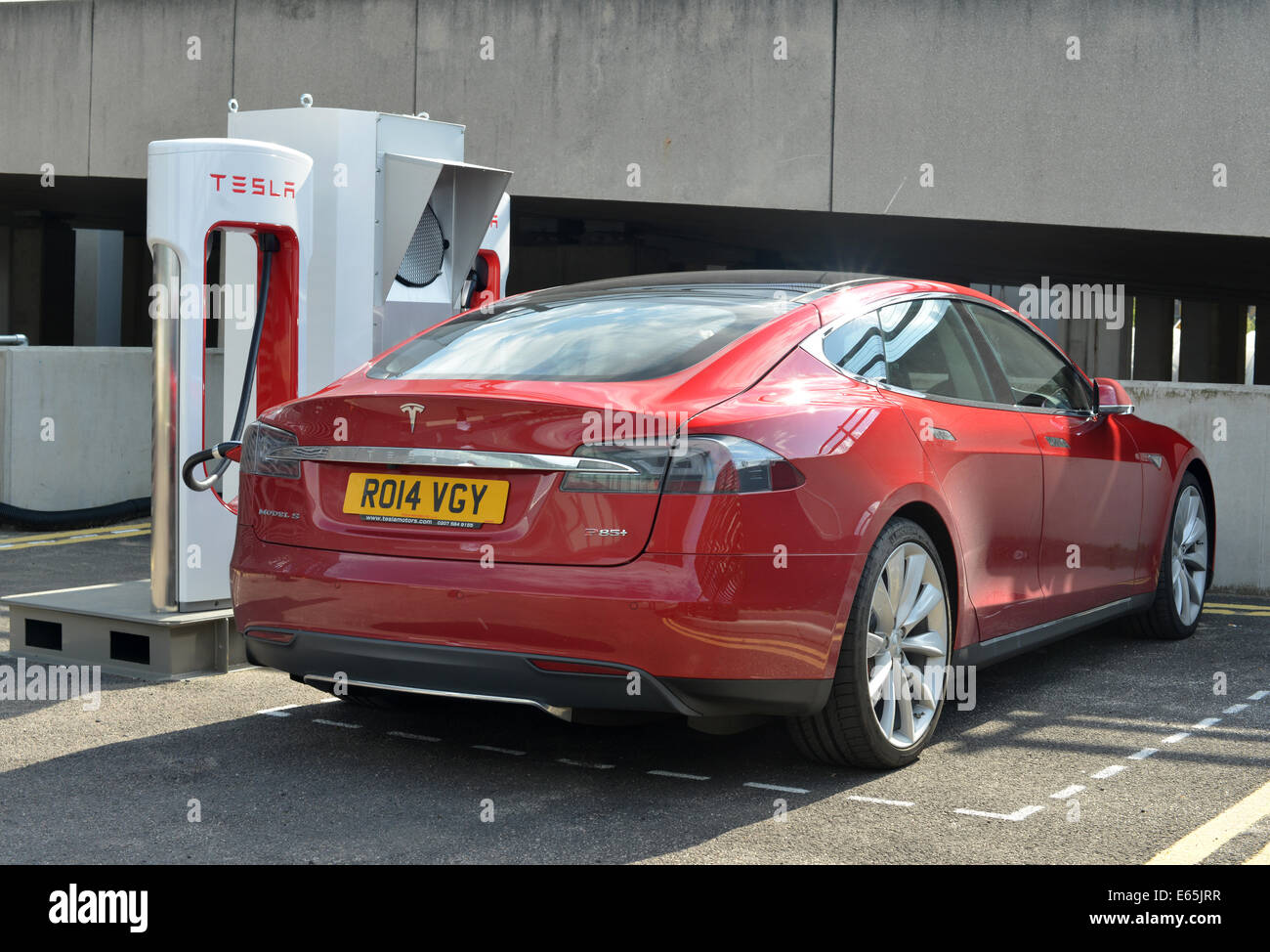 Tesla Model S electric super car charging at a Supercharger station