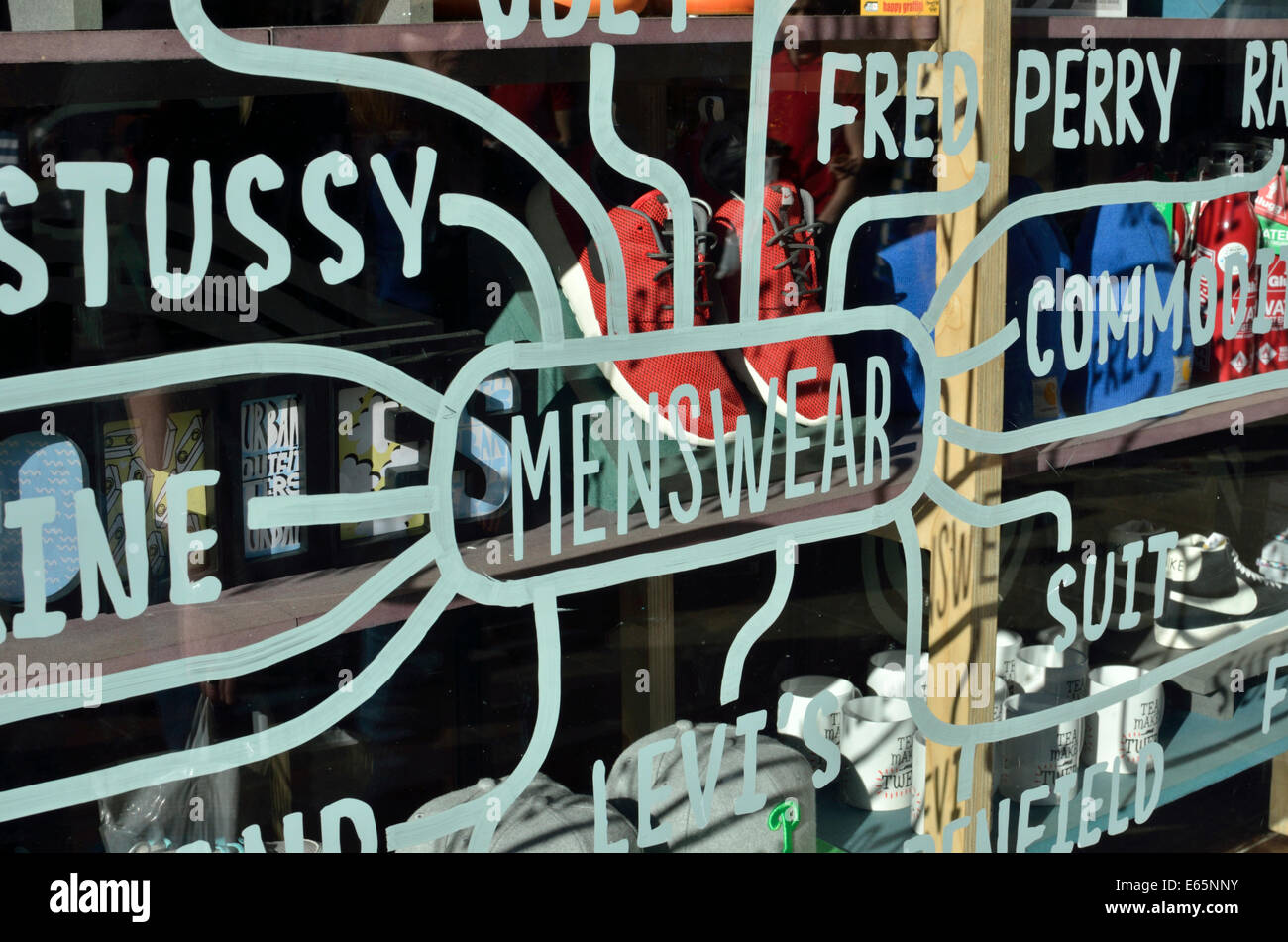 Menswear brand names on a shop window, London, UK Stock Photo