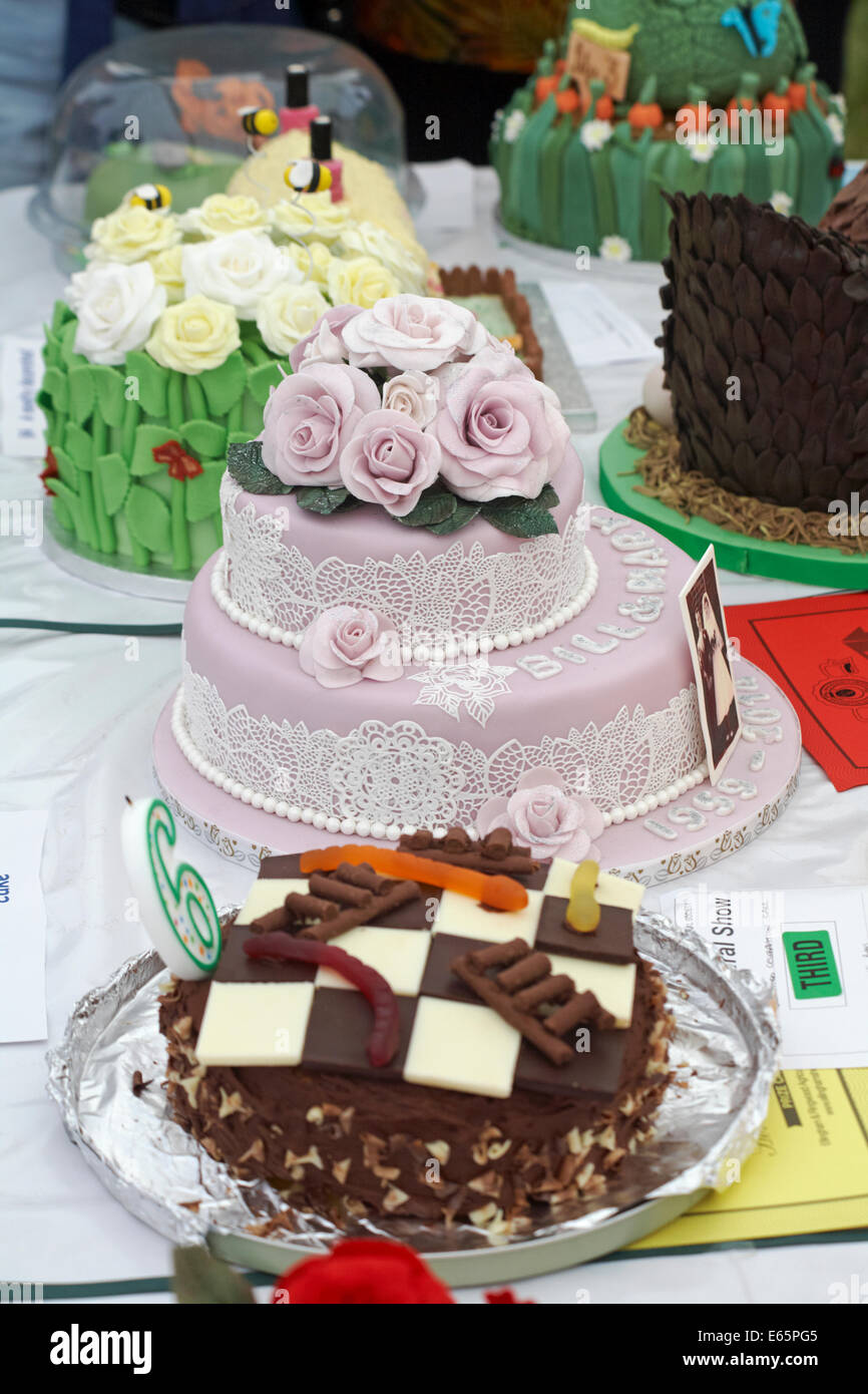 Decorated iced cakes at The Ellingham & Ringwood Agricultural Society Annual Show at Somerley Park, Ellingham, Ringwood, Hampshire, UK in August Stock Photo