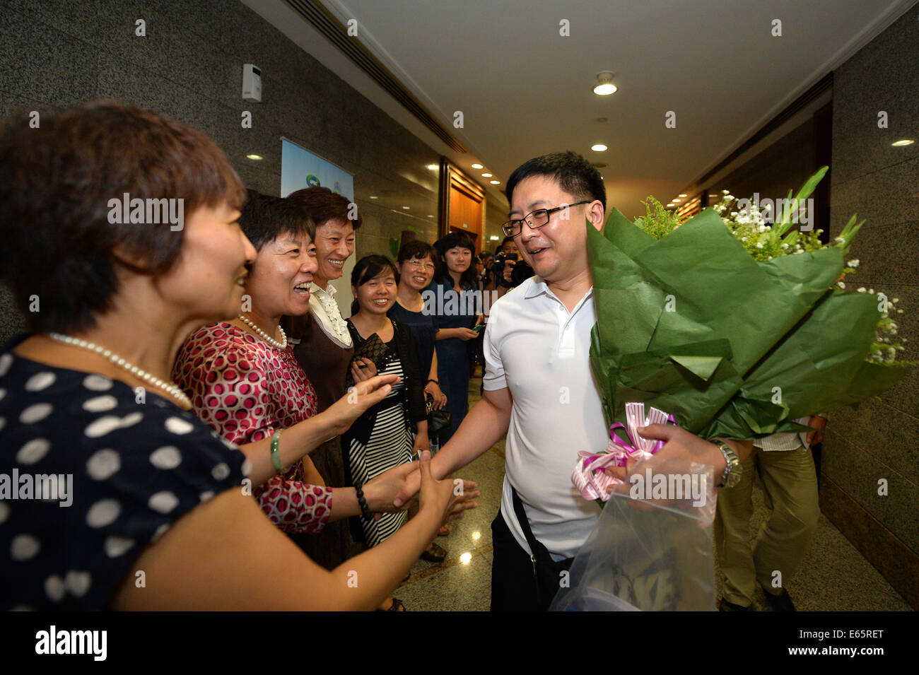 Beijing, China. 15th Aug, 2014. Li Xin (1st R), an expert on infectious ...