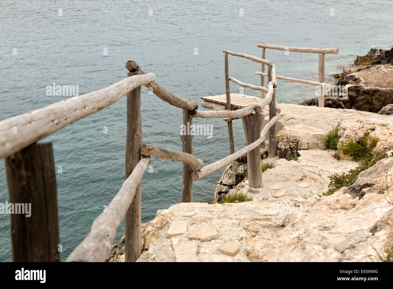 Wooden dock and handrail at a seaside cliff Stock Photo