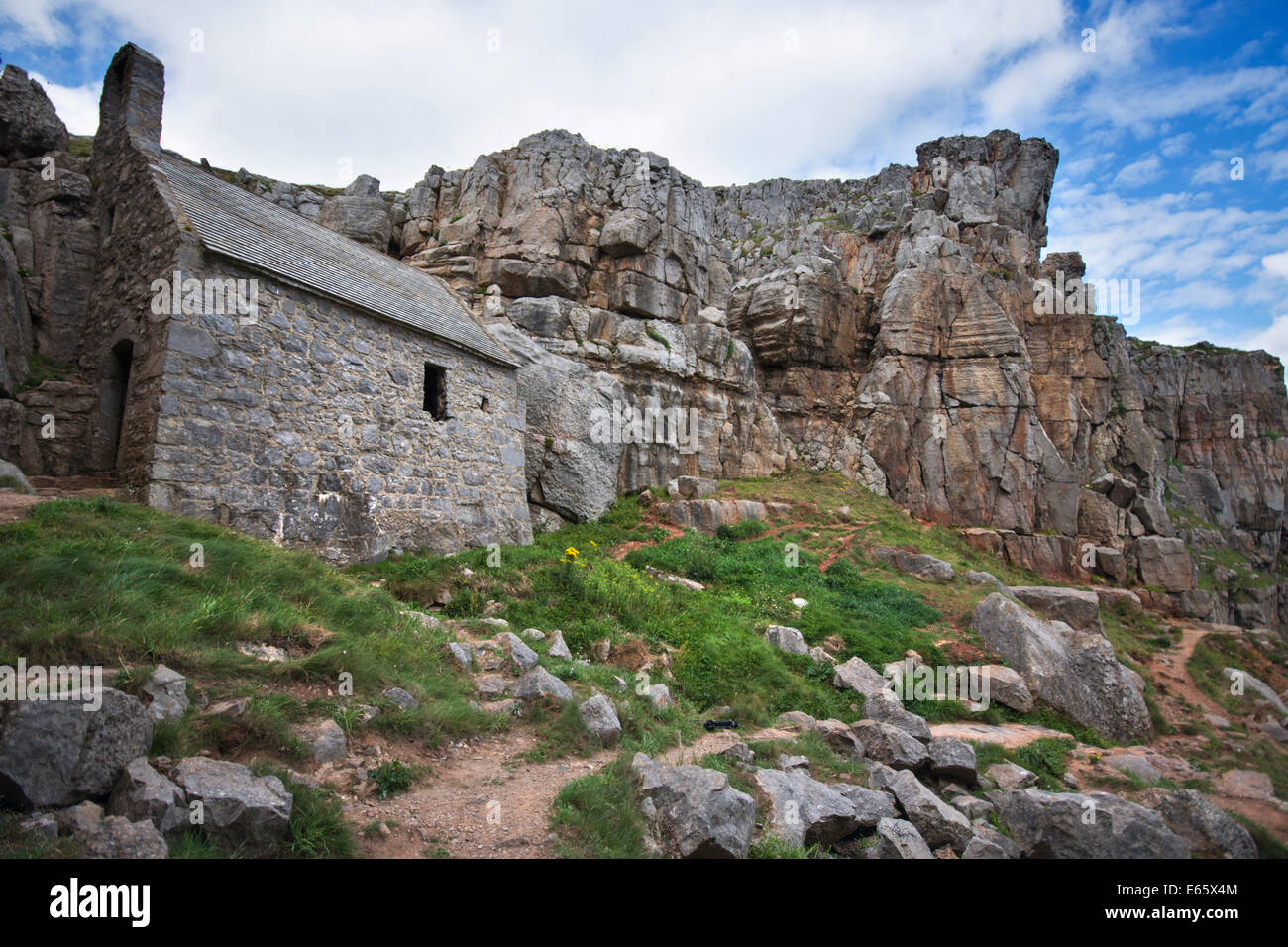 St Govan's Chapel tucked beneath the cliffs at St Govan's Head on the coast of Pembrokeshire in South Wales. Stock Photo