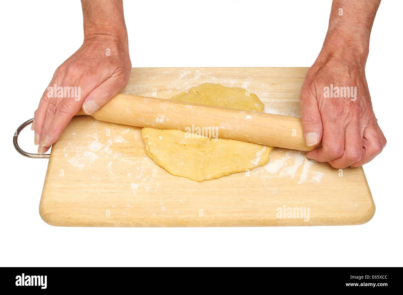 Closeup of a pair of hands rolling pastry on a floured board isolated against white Stock Photo