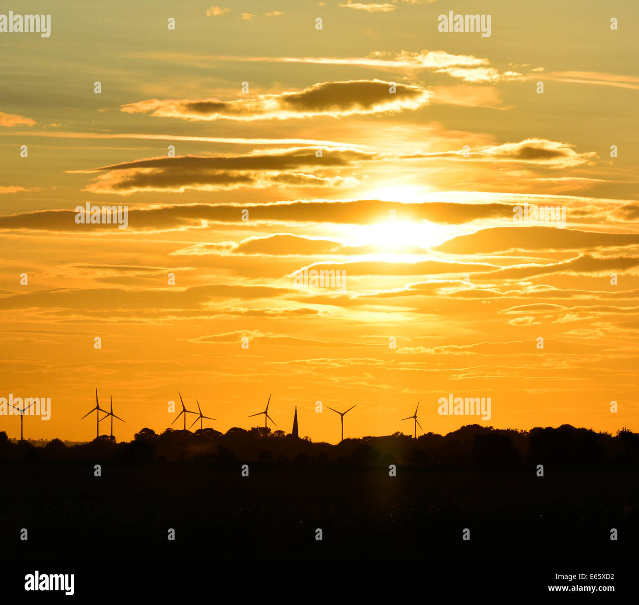 Sunset over wind farm Stock Photo