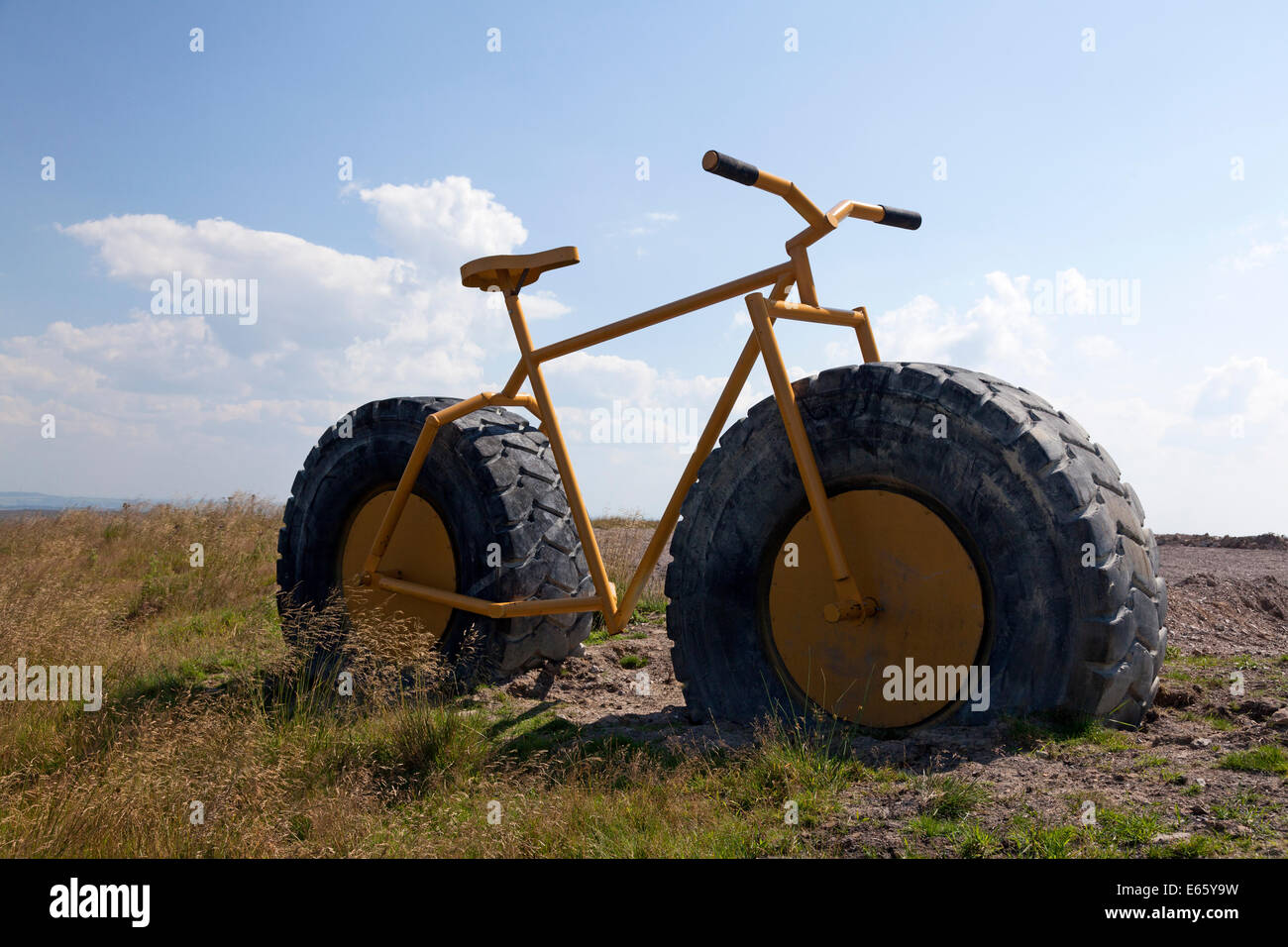 Large yellow bicycle with tractor-sized tyres at Coldstones Cut, Greenhow, North Yorkshire Stock Photo