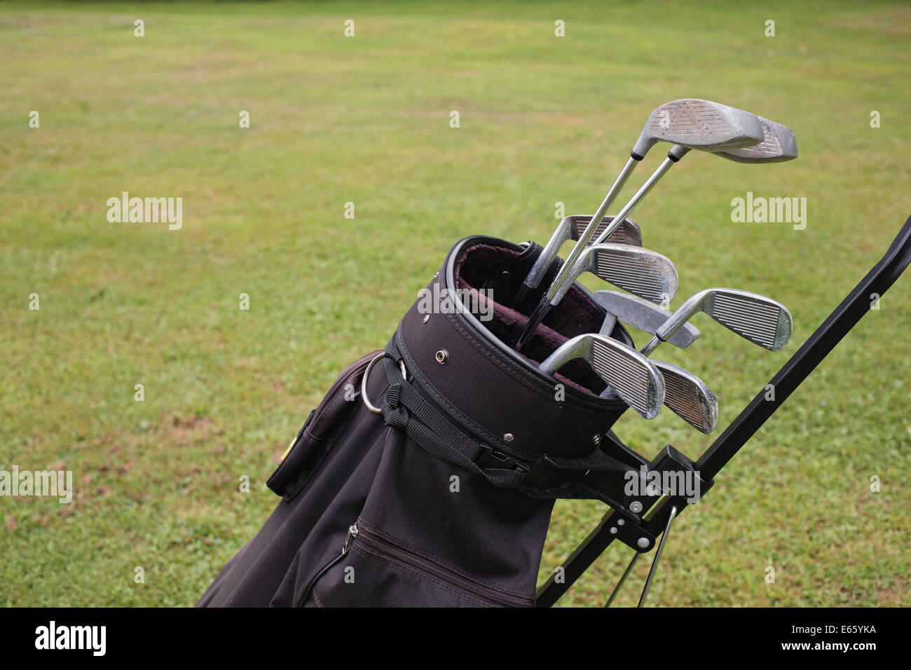 Golf clubs and bag detail with grass background. Stock Photo