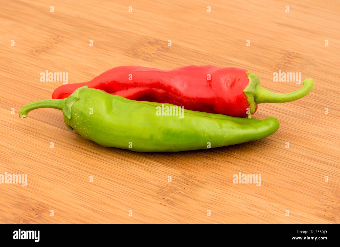 Chili Pepper, Red and Green on a bamboo chopping board Stock Photo - Alamy