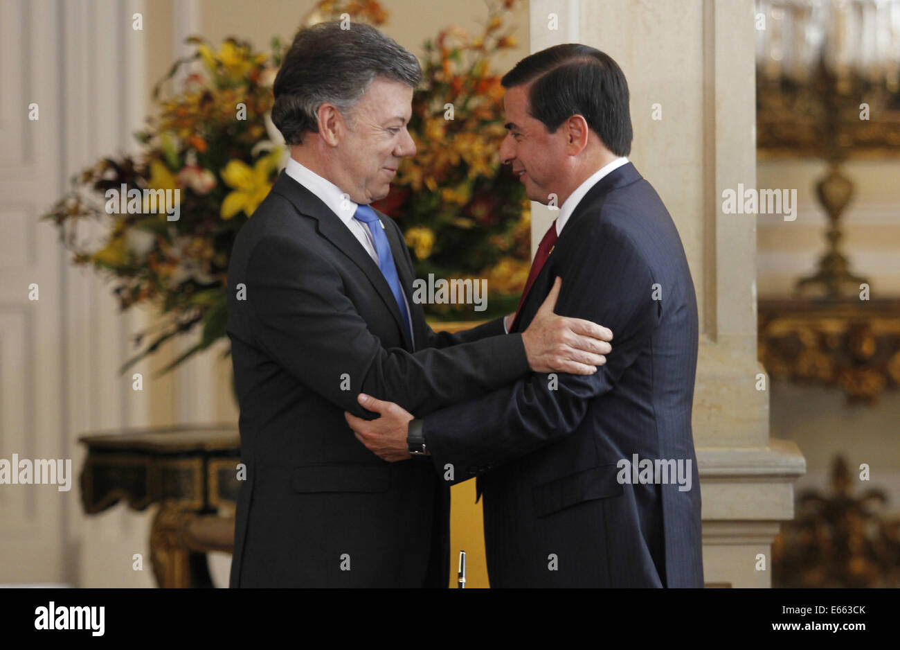 Bogota, Colombia. 15th Aug, 2014. Colombian President Juan Manuel Santos(L) hugs Juan Fernando Cristo after Cristo was sworn in as Colombia's Interior Minister in Bogota, Colombia, on Aug. 15, 2014. Credit:  Luisa Gonzalez/COLPRENSA/Xinhua/Alamy Live News Stock Photo