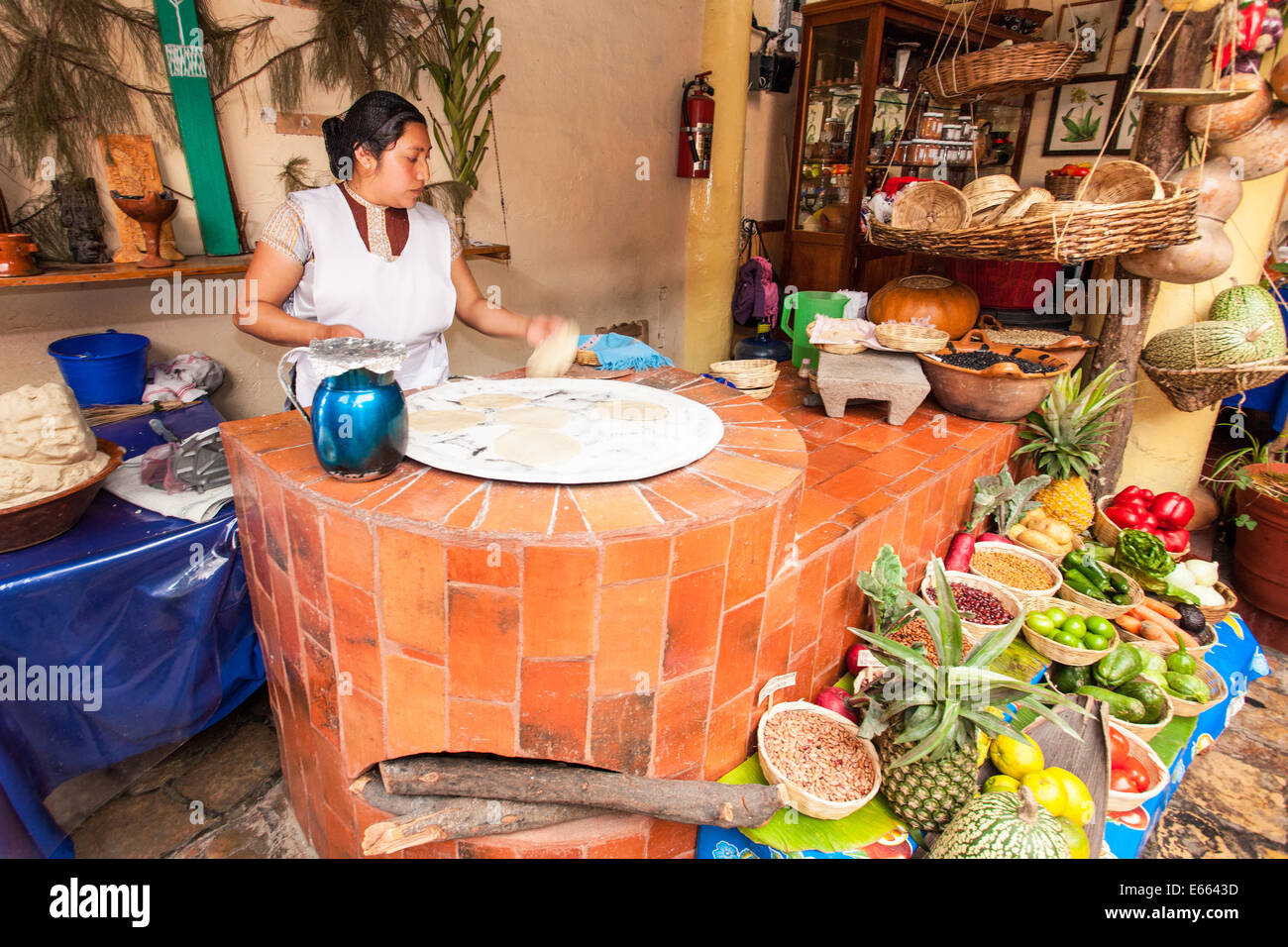 A woman cooks handmade tortillas in a restaurant near the plaza in San Cristobal de las Casas, Chiapas, Mexico. Stock Photo