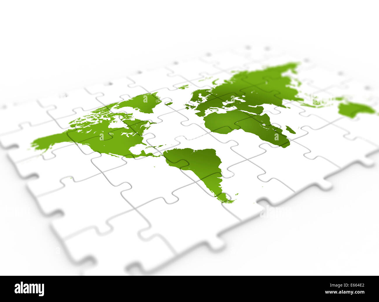 Green world map on puzzle piece Stock Photo