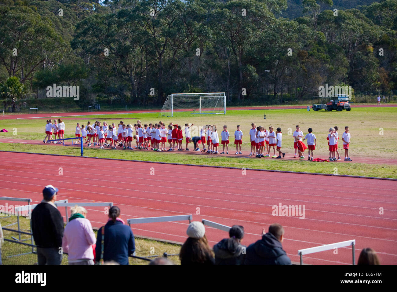 Young school children prepare for the long jump at a sydney school