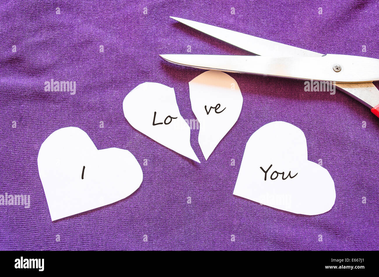 Scissors cutting paper with text I love you Stock Photo