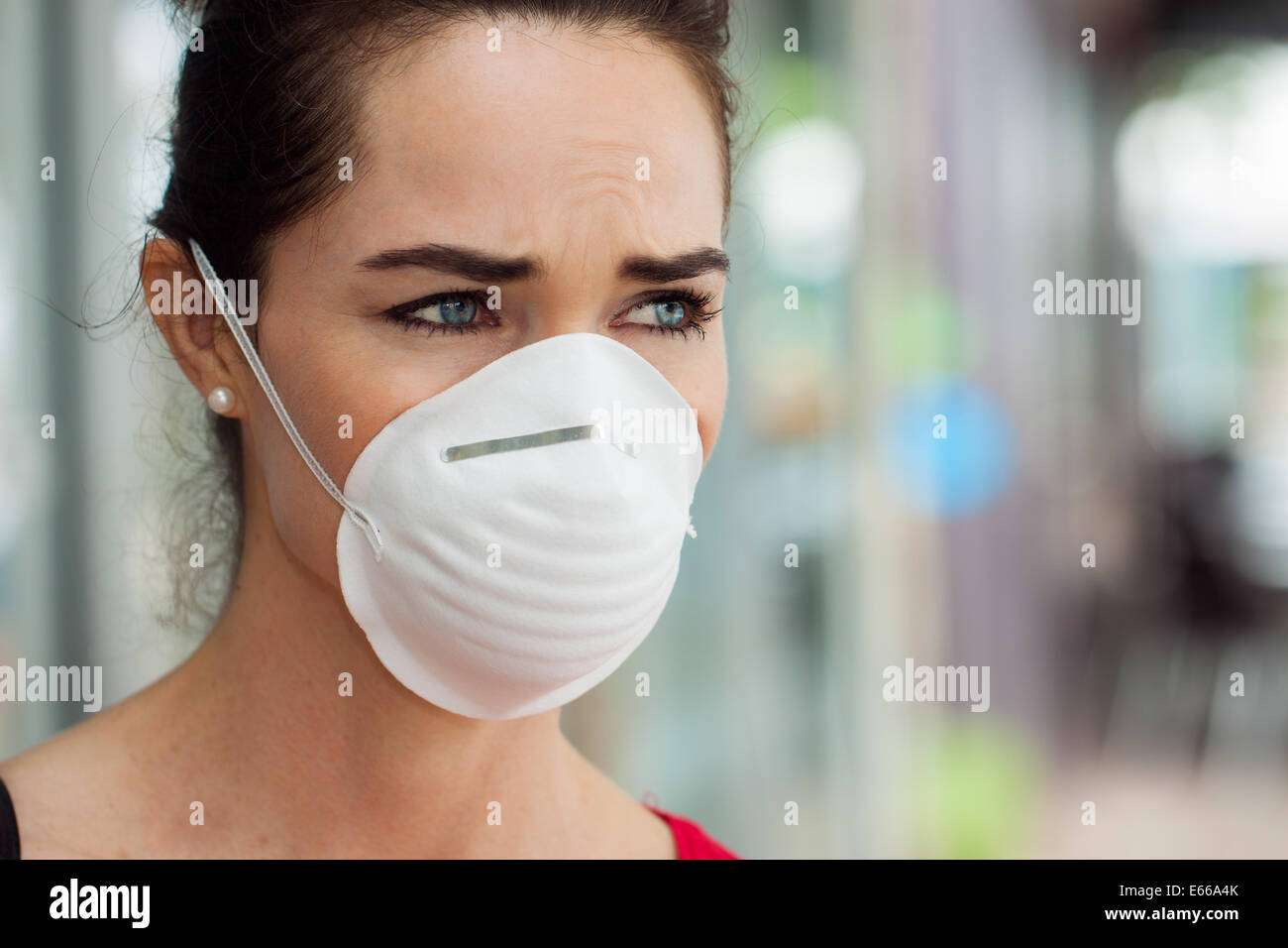 Close-up of a woman in the city wearing a face mask to protect herself from infection or air pollution. Stock Photo