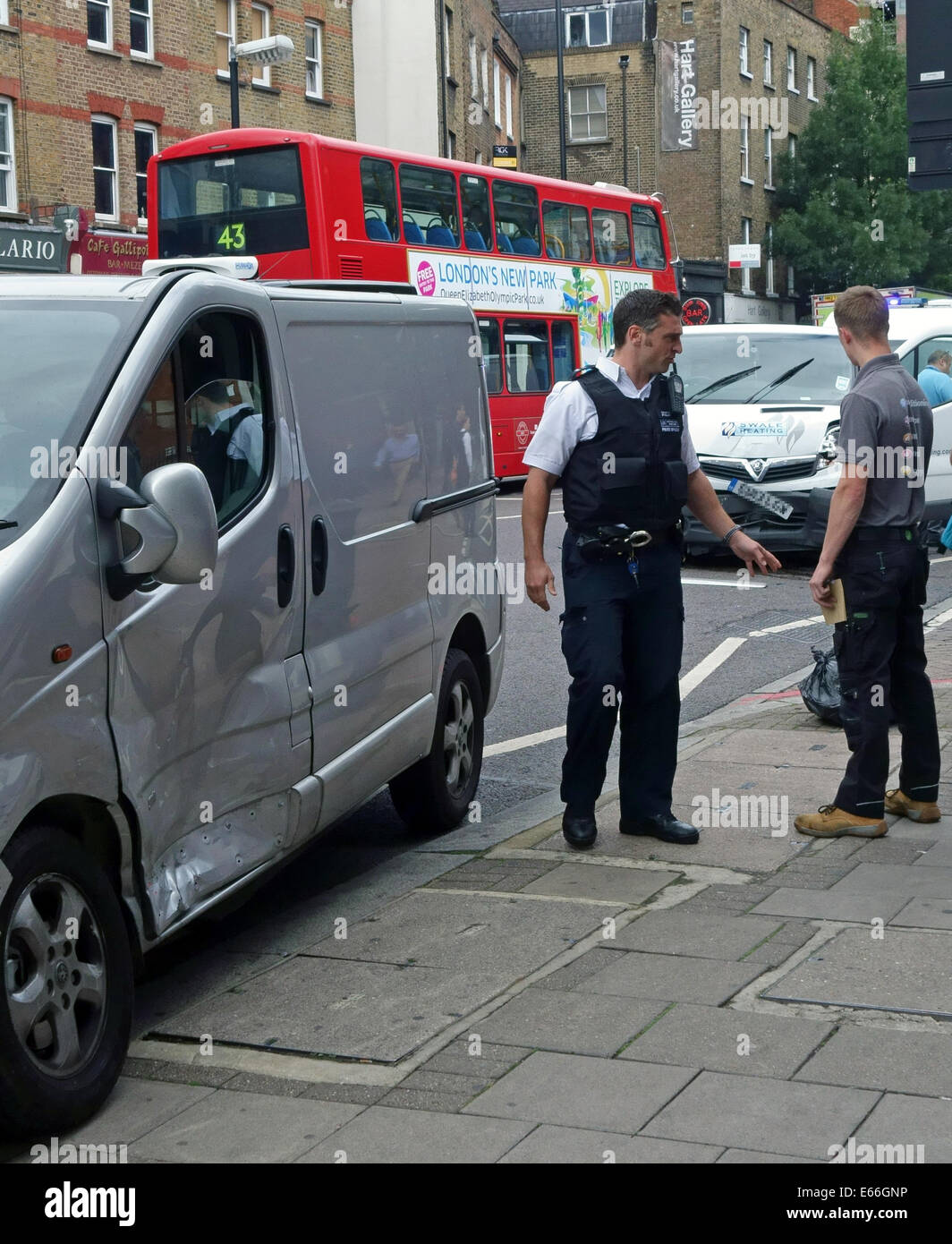 Police officer and driver at scene of road traffic accident in London Stock Photo