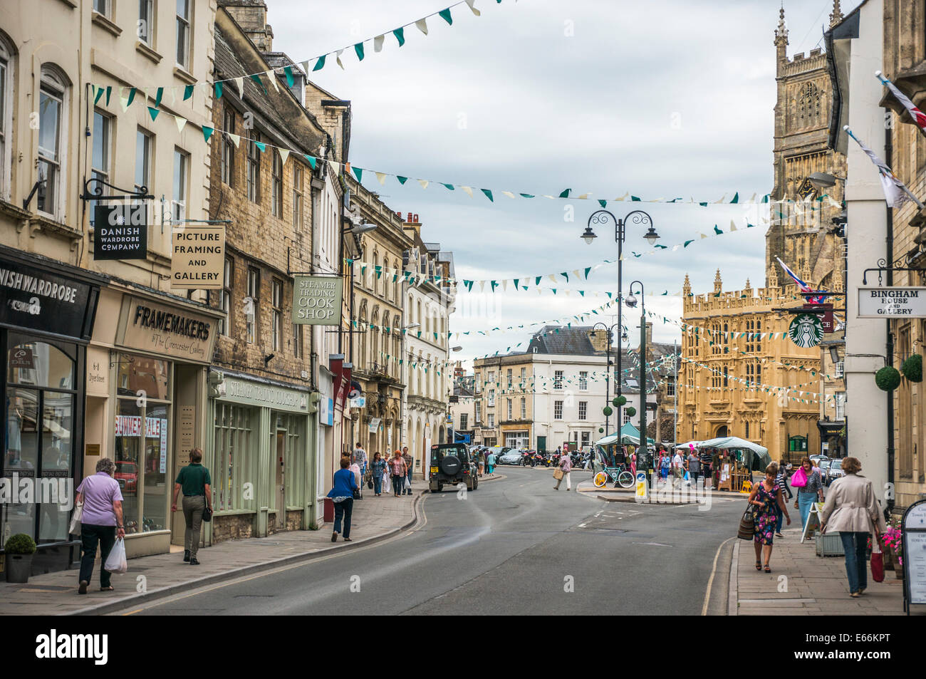 Town centre view, with church, period buildings, independent local shops and market stalls, Cirencester, Cotswolds, Gloucestershire, England, UK. Stock Photo