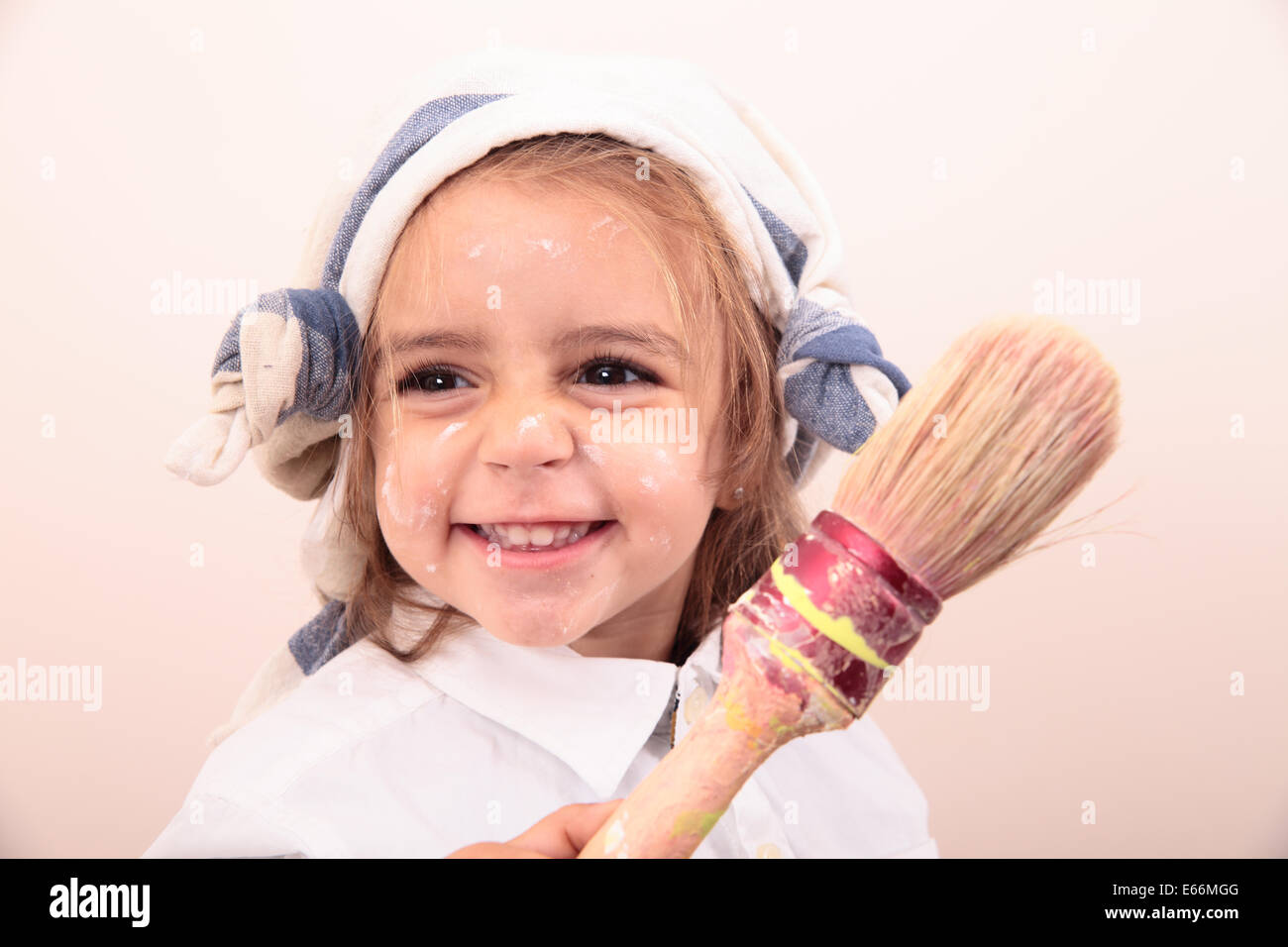 beautiful little girl painting and smiling Stock Photo - Alamy